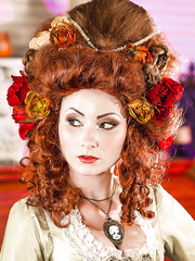 Beautiful redhead lady in white nylons uncovering her tattooed body