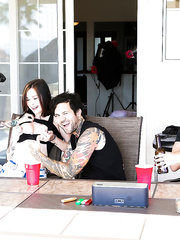 Tattooed darksome haired floozy in short petticoat gives sexy cook jerking during 3some