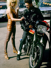 Vintage bitch with large hair disrobes to fuck a stranger on a motorcycle & eat cum