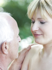 Excited golden-haired hotty receives on her knees stripped in the park to give oldman oral-stimulation