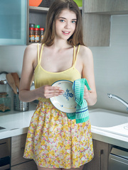 Youthful solo beauty Kay J disrobes for in nature's garb posing on kitchen counter