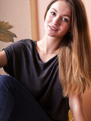 Fully dressed model Solveig shedding denim jeans to pose in the bare