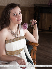 Dark Brown legal age teenager slides out of her costume to display her all natural slit