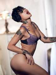 Super sexy swarthy Playgirl Gold bares her tattooed body and toys with a glass marital-device