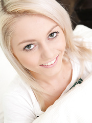 Cute legal age teenager Pinky June covers her bare bra buddies with hands in capri leggings