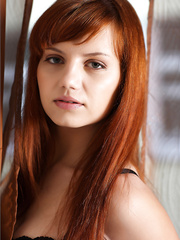 Erotic gorgeous redhead in darksome nylons & underware bending to show sexy booty