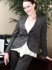 Businesswoman Veronica Snow shows off her curly bush in her home office