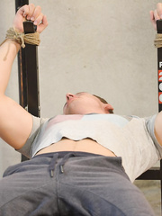 Female corporalist ties a chap to weight lifting bench a jerks his shlong