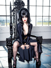 Black haired female Larkin Love exposes her large milk cans in fetish attire