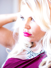 Stocking clad pornstar Tiffany Kingston baring large bra buddies and giving footjob