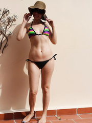 My sexy friend showing off her body in just her bikini and sun hat