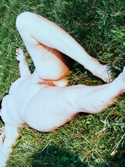 Mature slut wife sunbathing outside naked on the grass