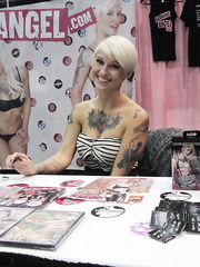 Tattooed females from Burning Girl receive nasty at an XXX trade show