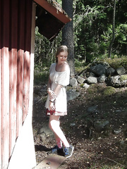 Darling girlfriend with large scoops positions in nature's garb in a deserted abode