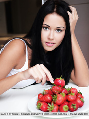 Darksome haired legal age teenager Macy B shows off her taught body over a bowl of strawberries