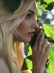 Brazen hussy Kira W sheds her short petticoat and top to lounge outside bare