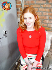 Pale redhead Cherry Poppens spits out sex cream after a gloryhole oral-service