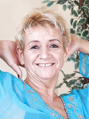 Lascivious golden-haired granny stripping and exposing her hirsute intimate parts