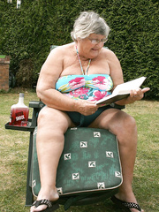Nasty dilettante granny Libby inserting a bottle in her overweight snatch in the garden