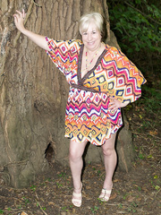 Thick older woman Speedybee disrobes undressed on a blanket down by the river