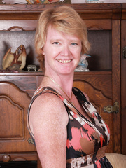Excited granny laughingly displays the moist cameltoe underneath her sheer undies