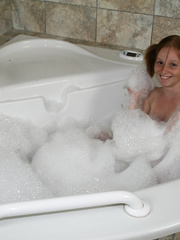 Juvenile looking redhead Alyssa Hart jerks off her stepfather in the bathtub