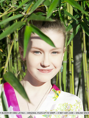 Hot little geisha Emily Bloom widening undressed to show hairless muff in the bamboo