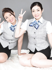 Dressed Japanese flight attendants engulf on every others toes previous to hugging
