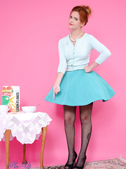 Redhead female Elle Richie removes her garments with aid from vacuum cleaner