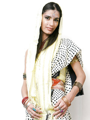 Indian solo model Tamara setting up candles for worship wit her garments on