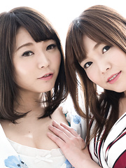 Cute Japanese lesbos strip whilst tongue kiss in a feverish manner