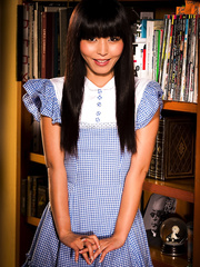 Japanese female Marica Hase flashes her pants during the time that taking a book from stack