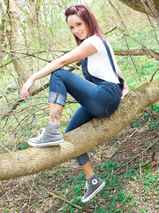 Breathtaking redhead chick Nikki removes her constricted shirt in the woods