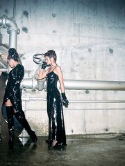 Lesbian Babes in lengthy latex dresses disrobe to hosiery and boots previous to toying snatches