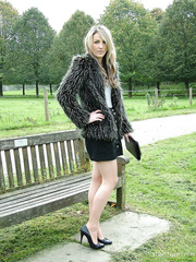 Leg model positions on a country bench in darksome petticoat and pumps