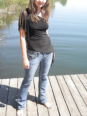 Brunette milf naked on the dock exposing pussy and beautiful body