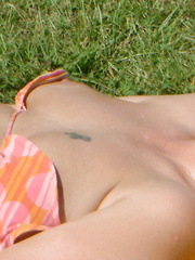 Tanning in the back garden and on the beach topless getting nice rays