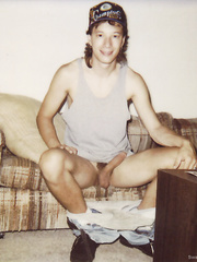 Twink Jean-Luc Nude and erect sitting on the couch with a hardon