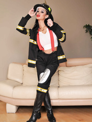 Female firefighter Angelina Valentine undresses off her uniform to pose exposed