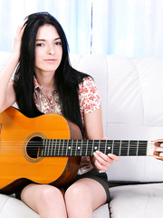 Juvenile brunette hair puts down her guitar and continues to masturbate in white socks