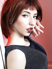 Redhead glam model disrobes to crotchless pants for slit play