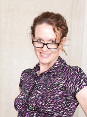 Midst-mature businesswoman takes off glasses and petticoat on way to posing stripped