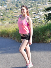 Sports beauty in shorts showing cameltoe & widening cookie for close up outdoors