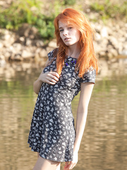 Hot redheaded legal age teenager positions her thin body in the in nature's garb by a stream