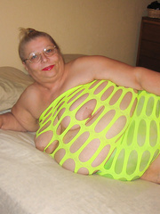 BBW mature woman showing off in a green dress on a web cam site
