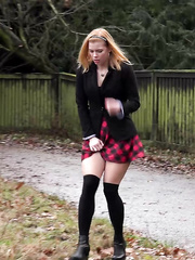 Schoolgirl Chrissy lifts a socks clad leg showing cookie whilst pissing outdoors