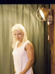 Blond woman exposes her clit whilst taking a piddle on WC in mesh stockings