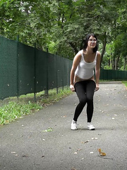 Glasses wearing playgirl pulls down her legging for a quick make water on on paved lot