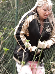 Golden-Haired hottie with a pierced cookie pulls down her panties to pee on fallen leaves