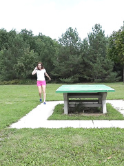 Dark Brown Antonia drops her panties to pee off the picnic table in the park